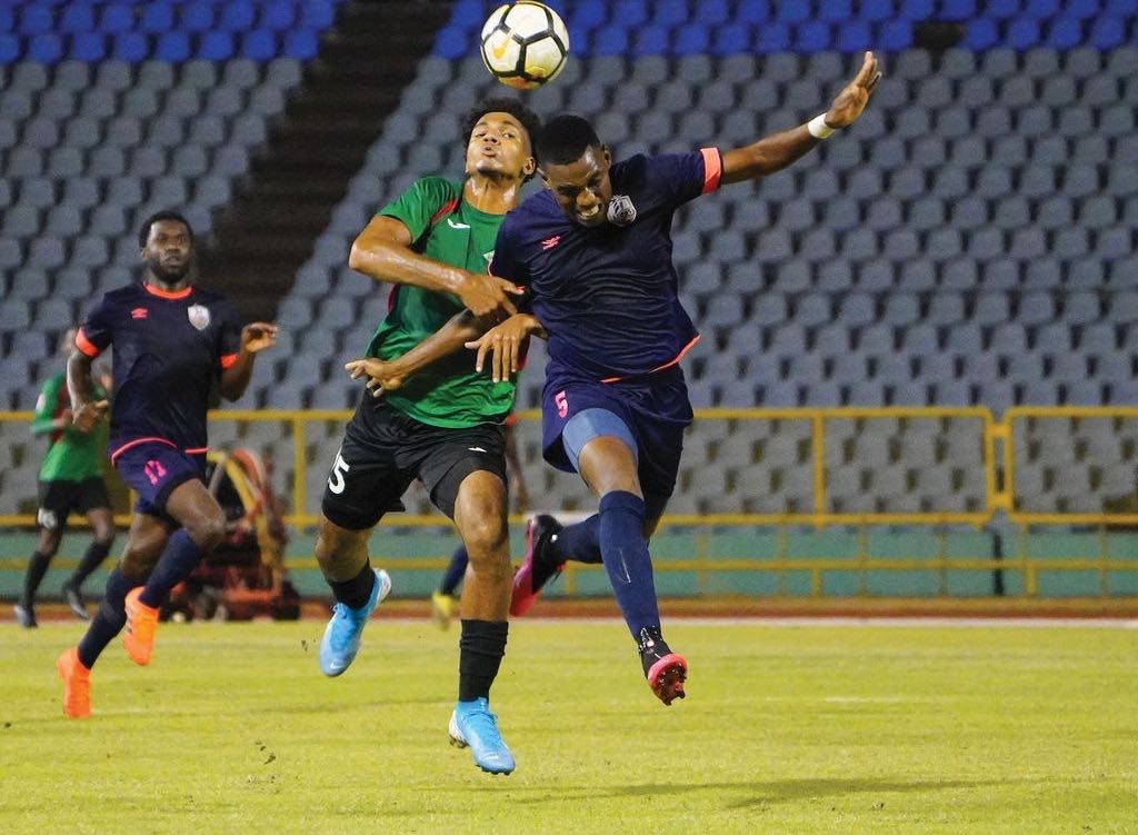 Athletic Club Port-of-Spain defender Seon Thomas, right, vies for the ball with Jabloteh's Justin Wilson during the TT Pro League match between San Juan Jabloteh and Athletic Club Port-of-Spain at the Hasely Crawford Stadium, Port of Spain on Tuesday night. Jabloteh won 1-0.   ...Daniel Prentice/CA-images