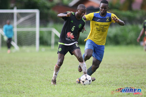 Photo: Petit Valley Diego Martin United playmaker Keron Cummings (left) tries to escape from a Central 500 Spartans opponent during TTSL Two action at the Diego Martin North Secondary ground on 15 July 2017 ...(Courtesy Chevaughn Christopher/Wired868)