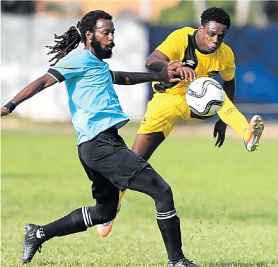 Cunupia FC’s Michael Darko, right, attempts to get pass QPCC’s Yohance Marshall on Matchday 7 of the T&T Super League at St Mary’s College Grounds, St Clair, on Sunday. QPCC won 2-1. PICTURE CA-IMAGES