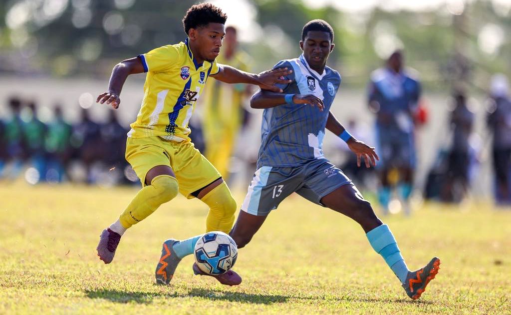 Fatima College Christian Bailey, left, takes on Arima North Secondary School player Theron O’Brien during the SSFL Premiership match at Fatima College ground in Mucurapo, Port-of-Spain, yesterday. Fatima won 2-0.... Keith Clement