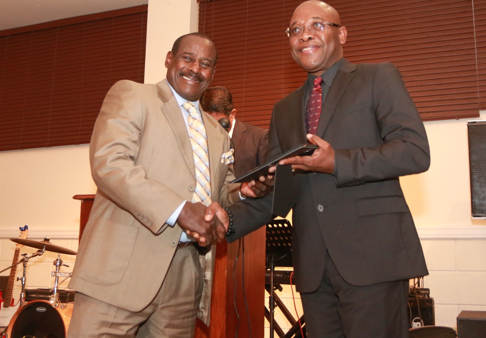 Everald Cummings receives his award from NLCB Chairman Marvin Johncilla at a TTFA Dinner on the visit of the FIFA President Gianni Infantino last Monday.