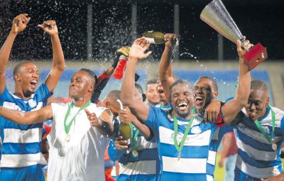 Captain of Guaya United Glenton Wolfe, holding trophy, celebrates with head coach Ron La Forest, second from left, and the rest of their team, following their 3-1 win over Prisons FC in the finals of the TTSL’s CFTL League Cup at the Ato Boldon Stadium, Couva.