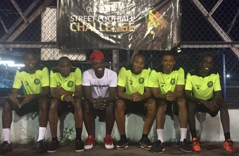 ZONAL CHAMPS: Kerry Joseph, second right, and Jerwyn Balthazar, right, pose with the other members of 2016 Guinness Street Football Challenge’s South Zone champions Jr Mafia at the Skinner Park basketball court in San Fernando, last Saturday.