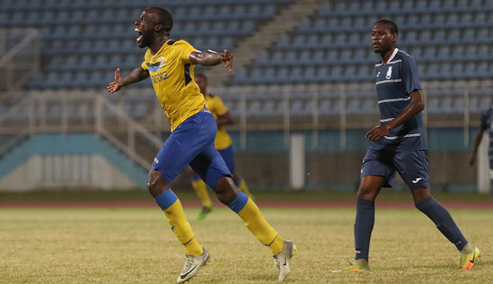 ​Jamille Boatswain, left, celebrates his first Defence Force hat-trick during a 4-0 win over Police FC in the semi-final round of the 2016-17 season Digicel Pro Bowl at the Ato Boldon Stadium on 12 Feb. 2017.