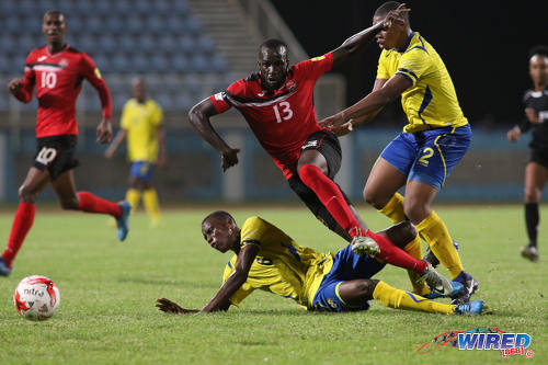 Photo: Trinidad and Tobago striker Jamille Boatswain (centre) tries to burst past two Barbados opponents during international friendly action at the Ato Boldon Stadium in Couva on 10 March 2017. Boatswain scored both goals in a 2-0 win for T&T. (Courtesy Chevaughn Christopher/Wired868)