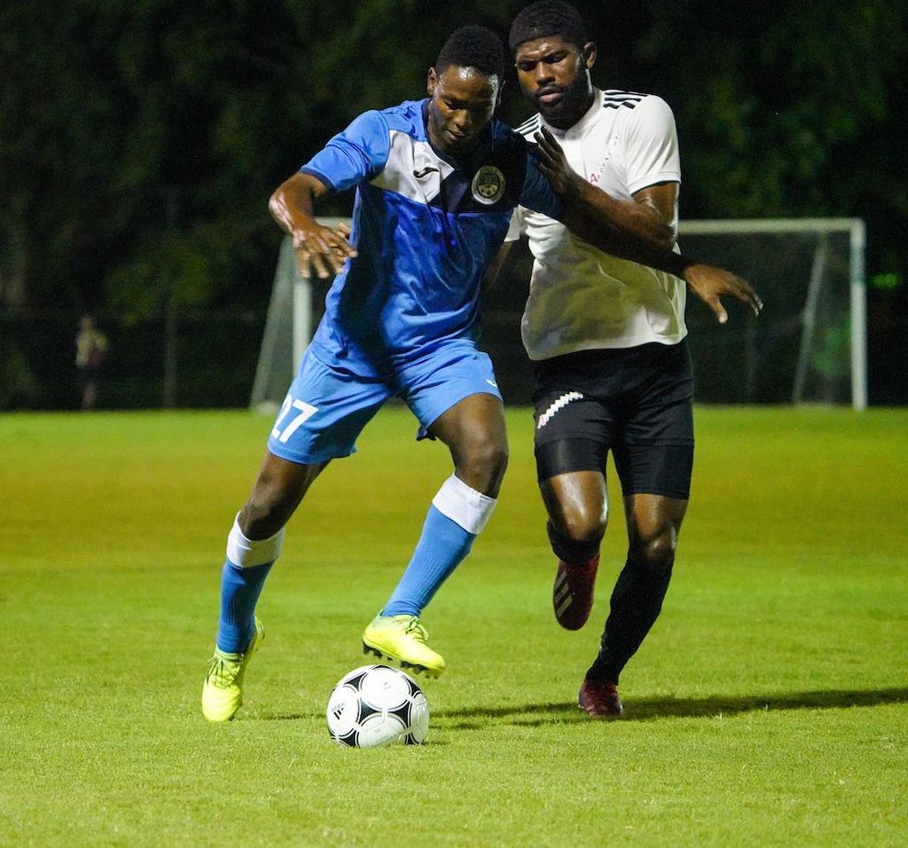 Police FC Kaydion Gabriel, left, holds off La Horquetta Rangers Kishun Seecharan during the TT Pro League match between La Horquetta Rangers and Police FC at the Phase 2 Recreation Grounds, La Horquetta on Tuesday night. Rangers won 2-0.  CA-images