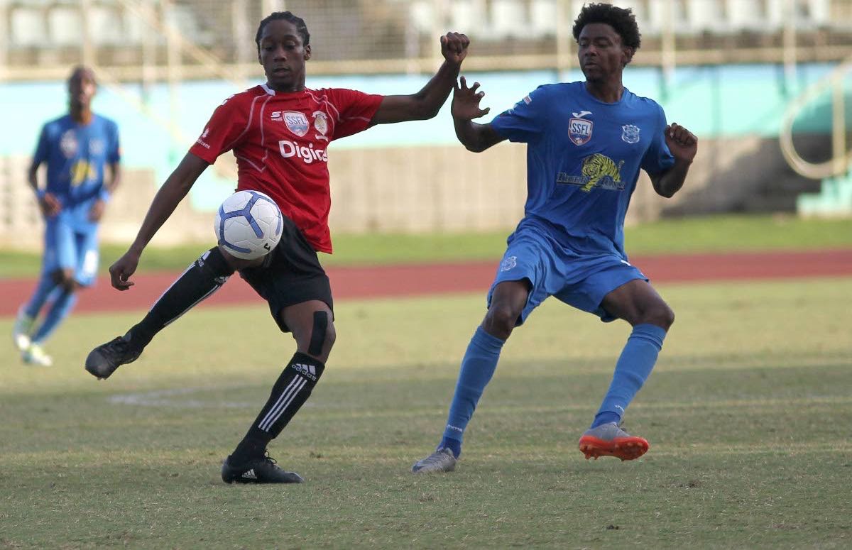 St Anthony’s Quinn Fredrick,left, and Naparima College’s Isa Bramble, vie for the ball during the semi-final encounter yesterday, at the Manny Ramjohn Stadium, Marabella. Naps won 2-0.
