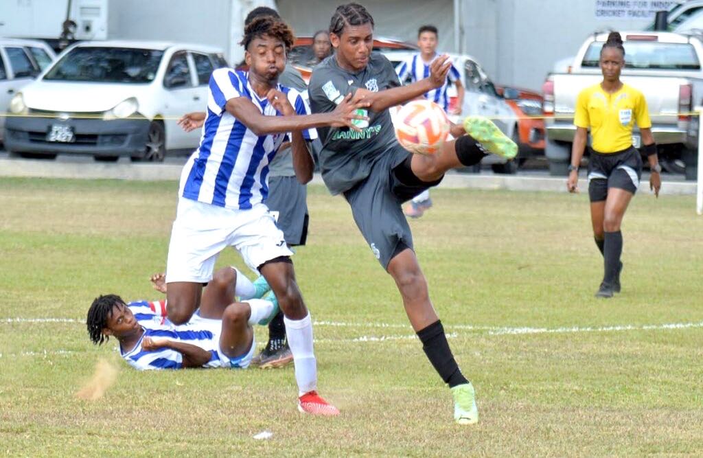 A Naparima College player kicks the ball under pressure from his St Mary's rival during a SSFL clash at St Mary's Ground, St Clair, earlier this season. - Dennis Allen for @TTGAMEPLAN