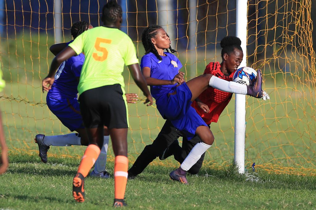 Pleasantville Secondary’s Alexcia Ali, second from right, has her shot saved point blank from Signal Hill's goalkeeper Aaliyah Alvarez, during the Girl's National Big 5 Finals at Plymoth Recreational Ground, Tobago. On Sunday, Ali scored nine goals in Pleasantville’s 15-0 over Fyzabad Anglican in the Girls Championships' South Zone competition in the Shell/First Citizens Secondary Schools Football League.
