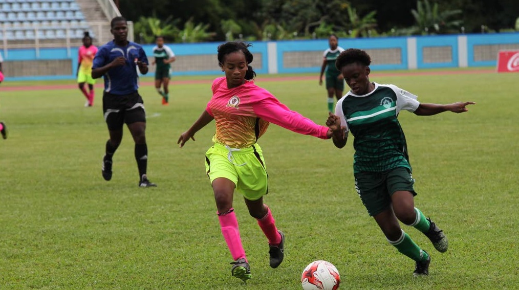 Pleasantville Secondary’s Kayla Maillard, left, battles St Augustine Secondary’s Mya Hernandez in the First Citizens National Girls Big 5 final at the Ato Boldon Stadium, Couva, yesterday.