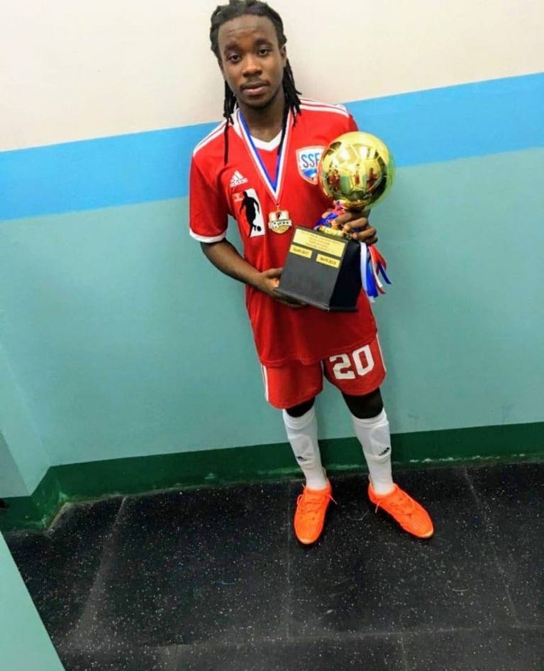 Ronaldo Jacob, poses with a trophy he won for being the player of a match after his North-South Classic football tournament at the Manny-Ramjohn stadium. PHOTO COURTESY RONALDO JACOB - RONALDO JACOB