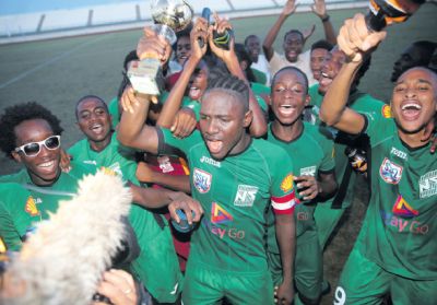 San Juan North’s captain Renaldo Boyce celebrates with the Intercol East Zone Champion’s Trophy and the rest of his team mates, following their 2 nil victory over Valencia Secondary at the Larry Gomes Stadium, Arima, yesterday.