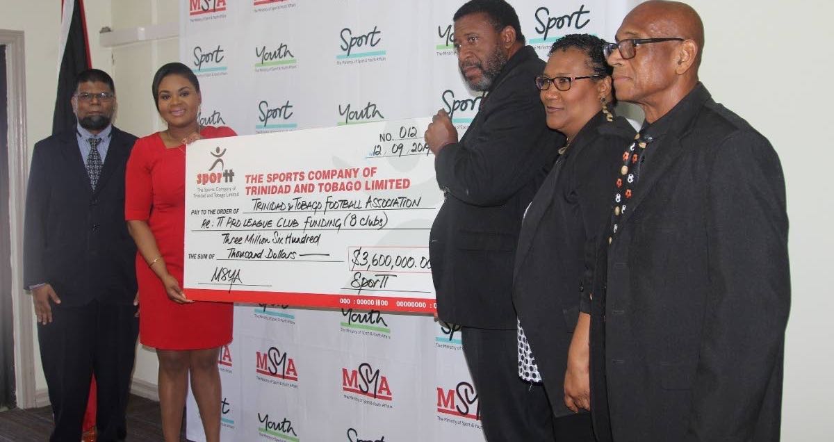 Shamfa Cudjoe, Minister of Sport and Youth Affairs, second from left, presents a cheque to David John-Williams, president of the TTFA. Looking on from left are Farook Hosein, permanent secretary, Ministry of Sport and Youth Affairs, Julia Baptiste, TTFA and Anthony Creed, Sport Company of TT.