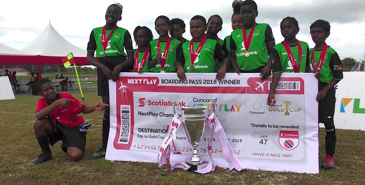 Members of the Siparia Boys RC with a couple girl representatives pose after capturing the CONCACAF NextPlay Cup yesterday.