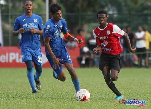 Photo: St Anthony’s College winger Tyrese Bailey (right) accelerates past Naparima College midfielder Justin Sadoo (centre) during SSFL Premier Division action at Westmoorings on 15 October 2016. ...(Courtesy Sean Morrison/Wired868)