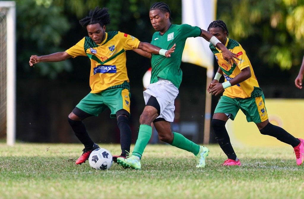 San Juan North attacker Lindell Sween, centre, tries to dribble his way past St Benedict's Jeremiah Niles, left, during the Secondary School Football League first round match at the San Juan North Secondary in Bourg Mulatresse on Wednesday, September 13th 2023. San Juan North won 4-3.