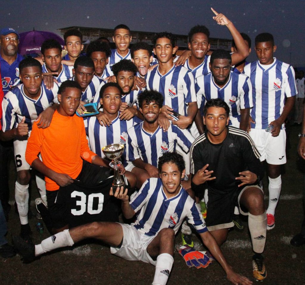 St Mary’s footballers pose with the Coca Cola North Intercol trophy yesterday after beating St Anthony’s 1-0 in the final at the Hasely Crawford Stadium, Mucurapo.
