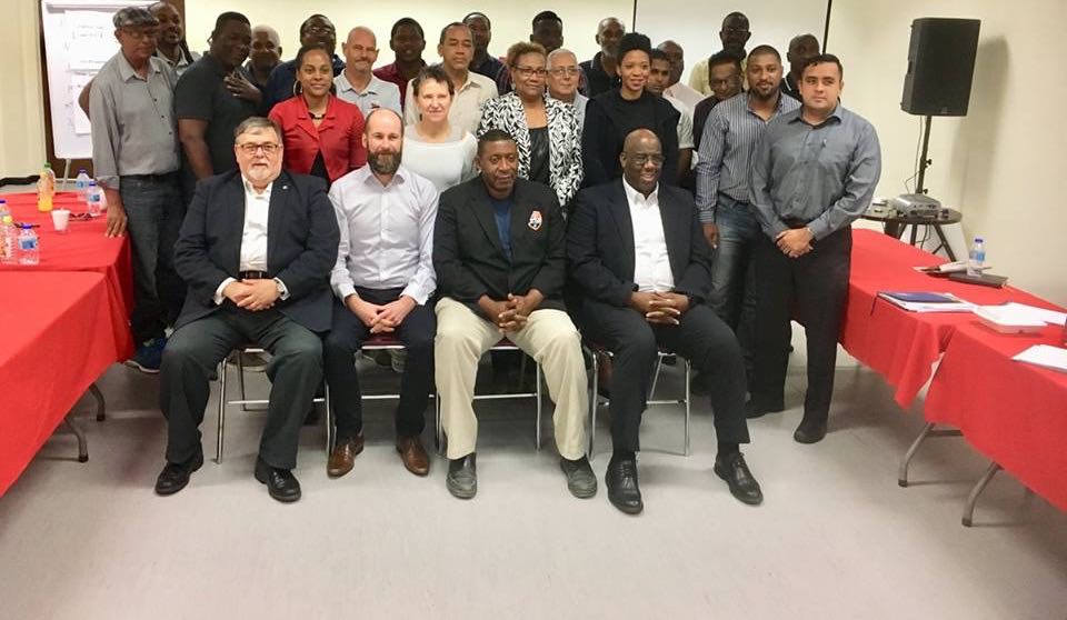 Efraim Barak, Eva Pasquier, Kenny MacLeod, all of UEFA ASSIST, and Howard McIntosh join TTFA president David John-Williams and TT Pro League clubs’ officials during a photocall on day two of UEFA/TTFA three-day Strategic Workshop at the National Cycling Velodrome in Couva, Trinidad on Apr. 5, 2018.