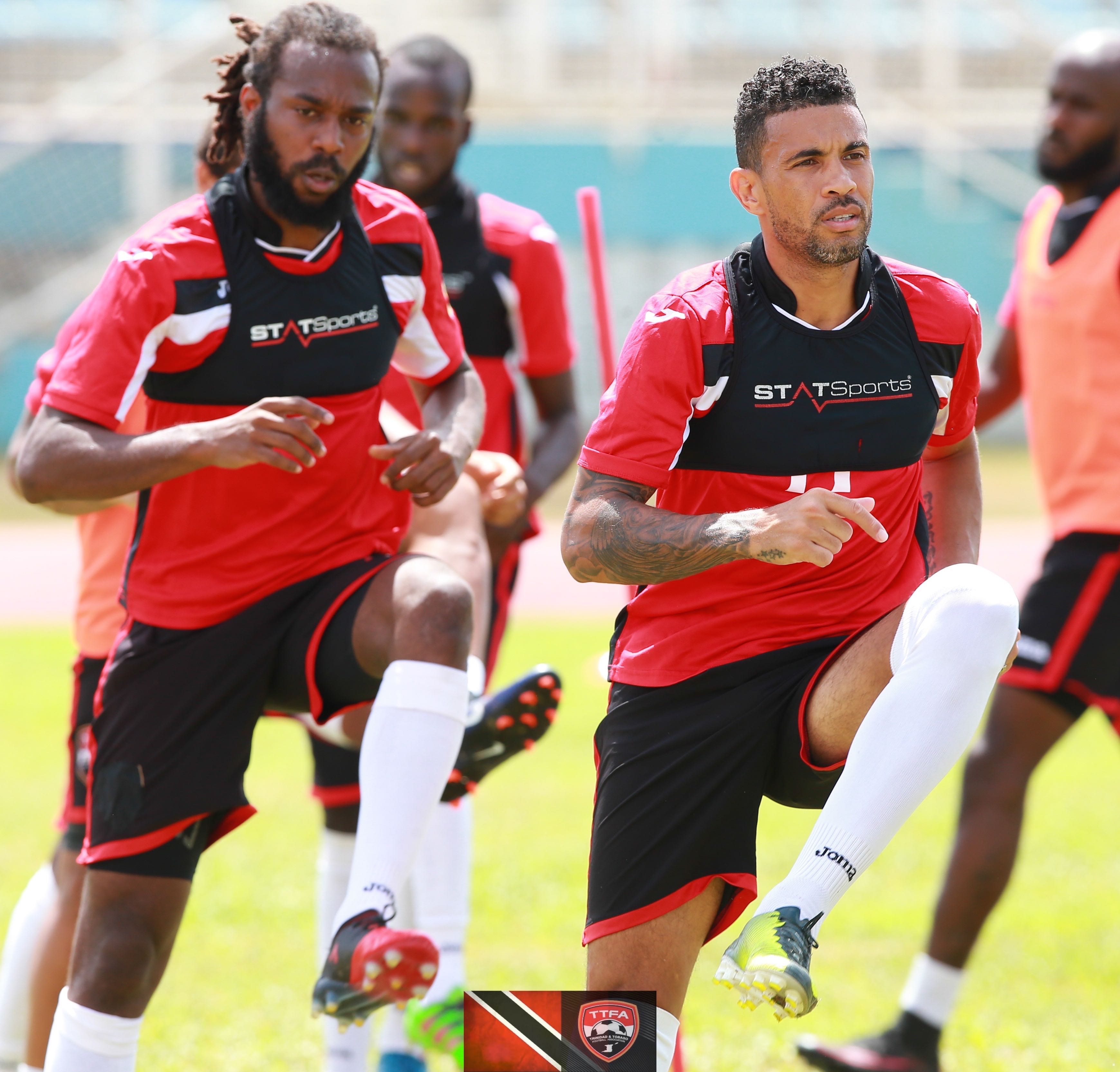 Super League MVP Marshall (left) and Carlos Edwards (right) training with T&T national football team.