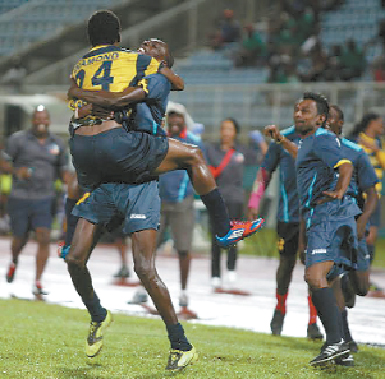 Club Sando midfielder Devon Modeste celebrates with a teammate after his match winning goal against Defence Force, in the semifinal of the Toyota Classic, at the Ato Boldon Stadium, Couva, on Saturday night. Photo: Anthony Harris