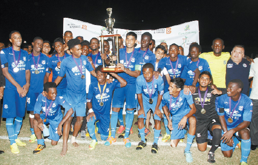 Naparima captain Amritt Gildharry, centre, celebrates with teammates and staff following their SSFL Premier Division Big-Four triumph at the Manny Ramjohn Stadium, Marabella, yesterday. Naparima drew 2-2 with St AnthonyÂ’s College but won the round-robin competition with a greater goal-difference. PHOTO: TONY HOWELL