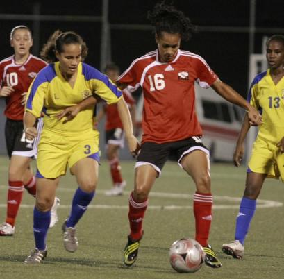 T&T’s Avanelle Isaac, right, holds off Barbadian Gabrielle Lopez in their Caribbean Football Union Second Round Group F Women’s Gold Cup/Central American and Caribbean Games (CAC) qualifiers at the Marvin Lee Stadium, Macoya on Wednesday night. T&T won 6-0. Photo: Anthony Harris