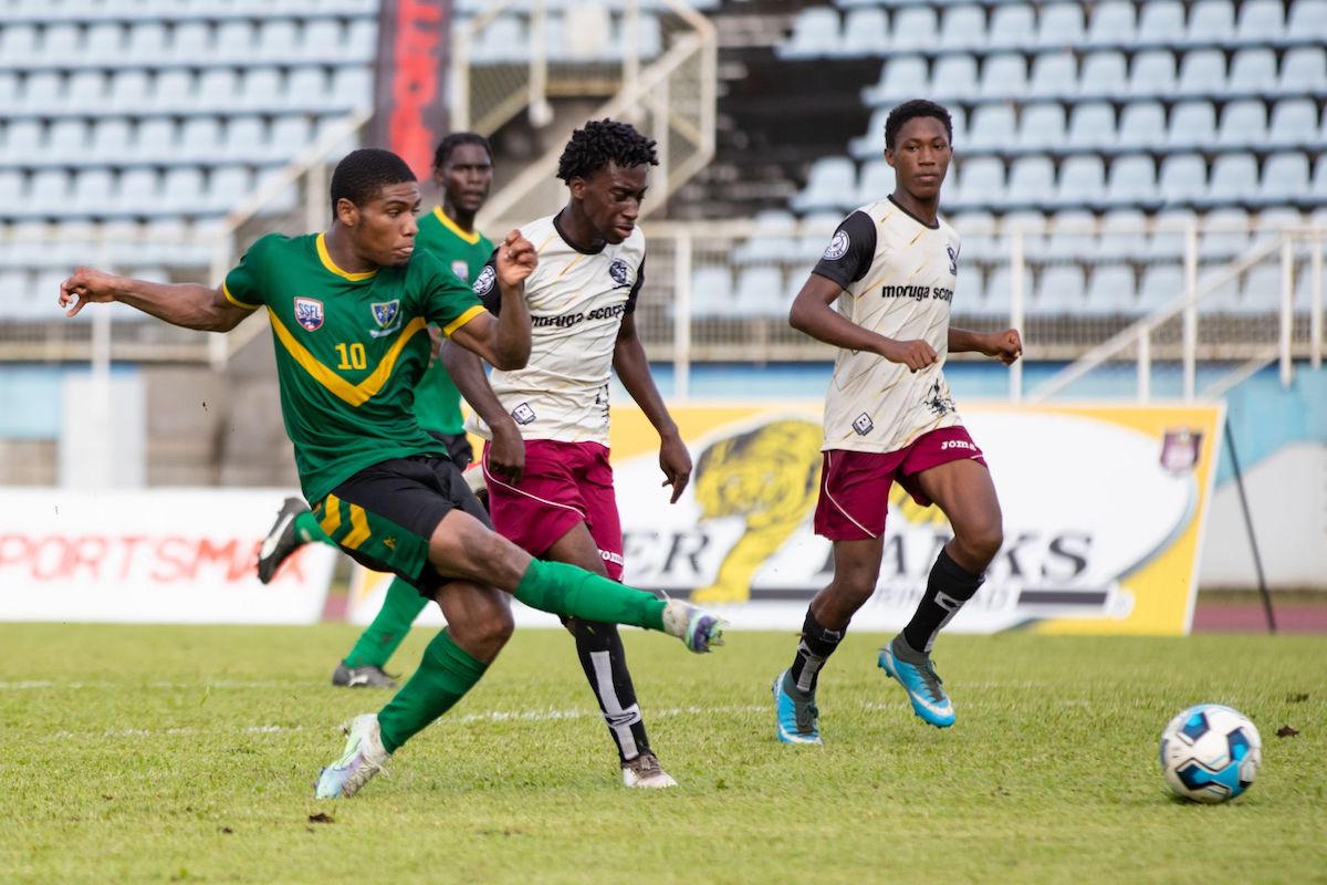 St Benedict’s College Nicholas Bobcome, left, shoots and scores while under pressure from a Moruga Secondary defender during the Secondary School Football League’s South Zone Intercol match at the Ato Boldon Stadium in Couva on November 16th 2022. St Benedict’s won 10-0. pHOTO: Daniel Prentice