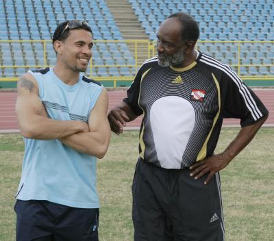 Soca Warriors and Ipswich winger, Carlos Edwards, left, shares a joke with T&T Football Federation Technical Director at the national team’s training session at the Hasely Crawford Stadium, Mucurapo, yesterday. ...Photo: Anthony Harris