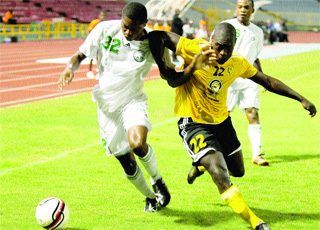 FIGHT ON: W Connection and new Trinidad & Tobago defender Mekeil Williams, left, battles T&TEC's striker Kerlon Ferguson for the ball. The teams played to a 1-1 regulation period draw in their First Citizens Cup semi-final match on Friday night at the Hasely Crawford Stadium. T&TEC advanced to the final 4-3 on penalty kicks. –Photo: Curtis Chase.