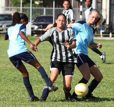 Holy Name’s Denise Tucker, centre, is tackled by Providence duo Kennisha Cedeno, left, and Jordan Van Reeken, in the BGTT Secondary Schools’ Football League Girls’ Championship, on Sunday. Providence won the match 1-0. Photo: Anthony Harris.