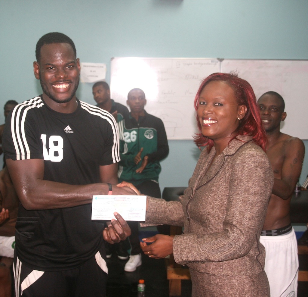Trinidad and Tobago national football team captain and goalkeeper Jan-Michael Williams recieves a check from SWO