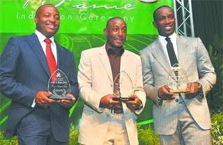 Memory makers: Brian Lara, from left, Russell Latapy and Dwight Yorke with their awards at the First Citizens Sports Foundation Hall of Fame ceremony last week at the Hyatt Regency hotel, Port of Spain. –Photo: ISHMAEL SALANDy