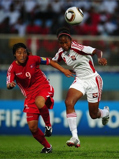 COUVA, TRINIDAD AND TOBAGO - SEPTEMBER 12: O Hui Sun of North Korea battles with Liana Hinds of Trinidad and Tobago during the FIFA U17 Women's World Cup Group A match between North Korea and Trinidad and Tobago at the Ato Boldon Stadium on September 12, 2010 in Couva, Trinidad And Tobago. (Photo by Laurence Griffiths - FIFA/FIFA via Getty Images) 