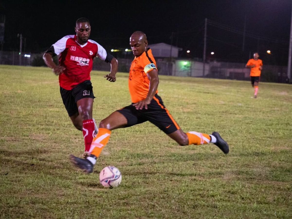 Take That and Cool It captain kicks the ball under pressure from a Mayaro United player in the Sweet Sixteen Football League in Sangre Grande on May 5th 2022.