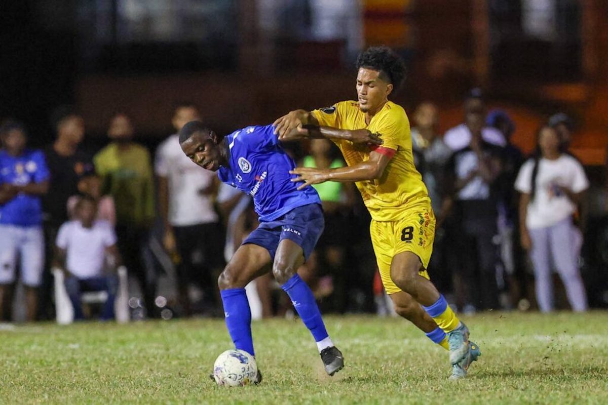 Police FC Jabari Mitchell (left) holds off AC Port of Spain's Michel Poon-Angeron to keep possession during the T&T Premier Football League match at the Police Barracks on Friday, January 12th 2024 in St James. PHOTO BY: Daniel Prentice