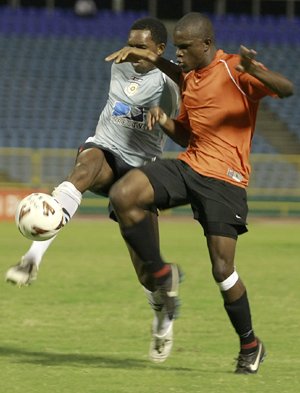 Charles Pollard, right, of DirecTV North East Stars, makes a timely clearance to deny Jerrel Britto of San Juan Jabloteh a shot on goal during their Digicel Pro League match at the Hasely Crawford Stadium, Mucurapo on Friday