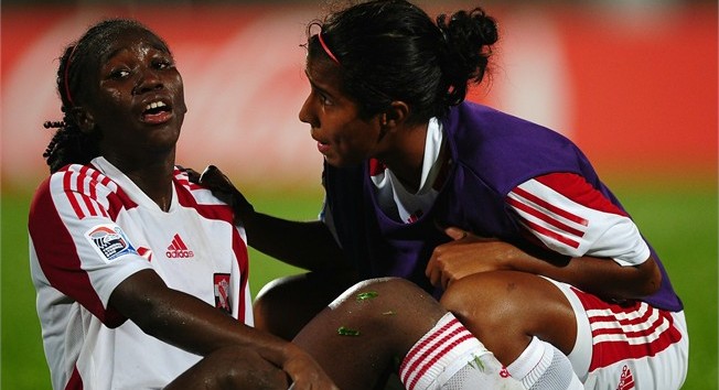 COUVA, TRINIDAD AND TOBAGO - SEPTEMBER 12: Patrice Vincent comforted by teammate Emma Abdul of Trinidad and Tobago shows her dispair after losing to North Korea during the FIFA U17 Women's World Cup Group A match between North Korea and Trinidad and Tobago at the Ato Boldon Stadium on September 12, 2010 in Couva, Trinidad And Tobago. (Photo by Laurence Griffiths - FIFA/FIFA via Getty Images) 