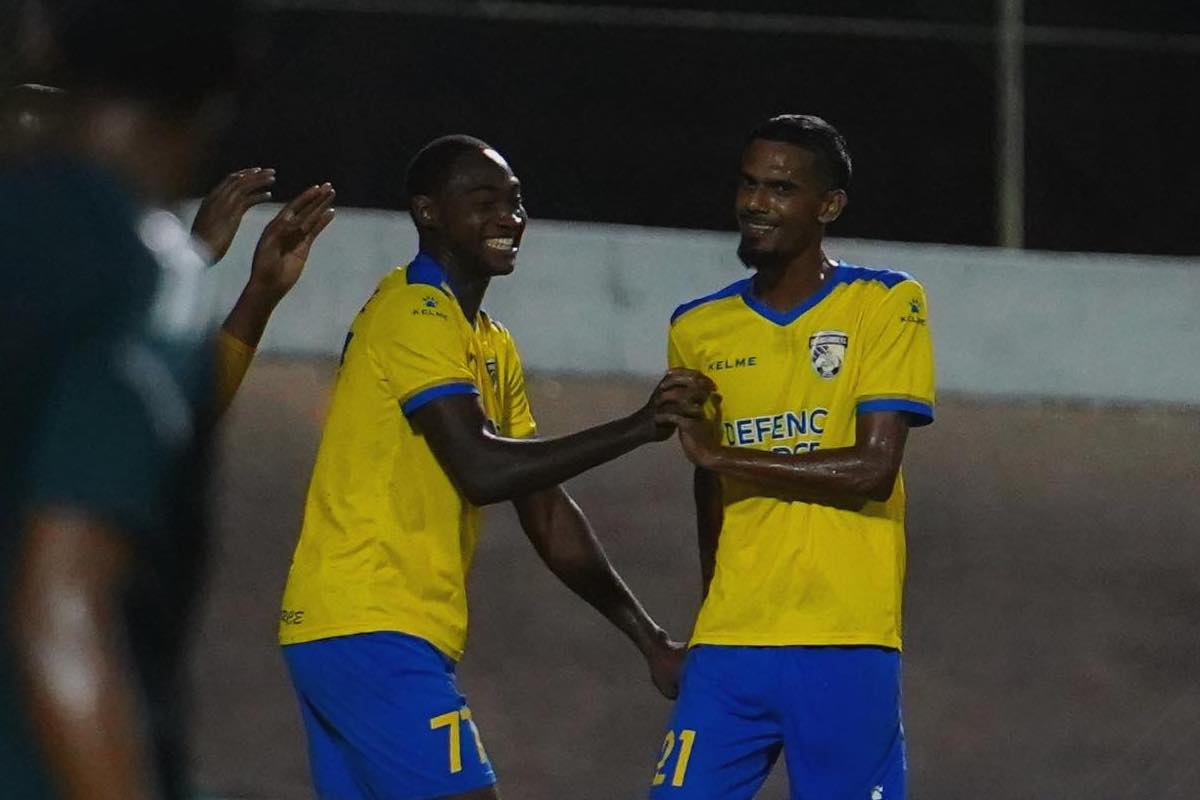 Defence Force's Kathon St. Hillaire (left) celebrates with Justin Sadoo (right) after scoring a goal against Prison Service FC at Arima Velodrome on Friday, December 8th 2023.