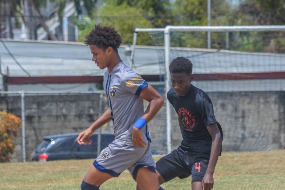City FC forward Reagan Rowe (left) takes on a Cardinals FA opponent during their Republic Cup 2024 under-14 semifinal at the Hasely Crawford Stadium training field in Mucurapo on May 11th 2024.