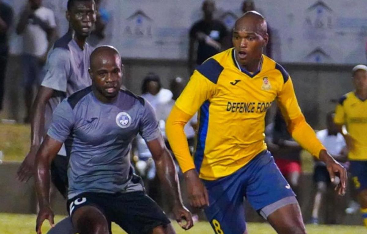 Defence Force FC's Brent Sam (right) battles Police FC's Elijah Belgrave (right) for the ball during a T&T Premier League match at St. James' Barracks on Sunday, March 26th 2023