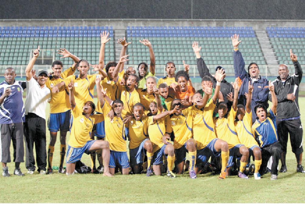 Shiva Boys Hindu College players and staff celebrate its first Coca-Cola South Zone InterCol triumph following a 4-2 penalty kick win over Presentation College, San Fernando, after both teams ended full time goalless. Shiva will meet St Anthony’s College in the national semifinal, at the Hasely Crawford Stadium in Mucurapo tomorrow at 4 pm. Photo: Anthony Harris.
