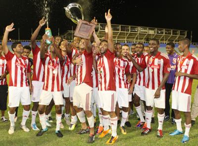 Members of the victorious St Anthony’s College show off their trophies after winning 2011 Coca Cola interCol title yesterday. The ‘Tigers’ defeated Arima North 3-0 in the finals. Photo:ANTHONY HARRIS 