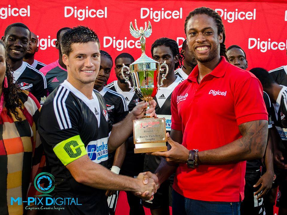 Central FC’s vice captain, Sean De Silva, receives the Rawle Fletcher Trophy after the first round of the 2014/15 T&T Pro League season.