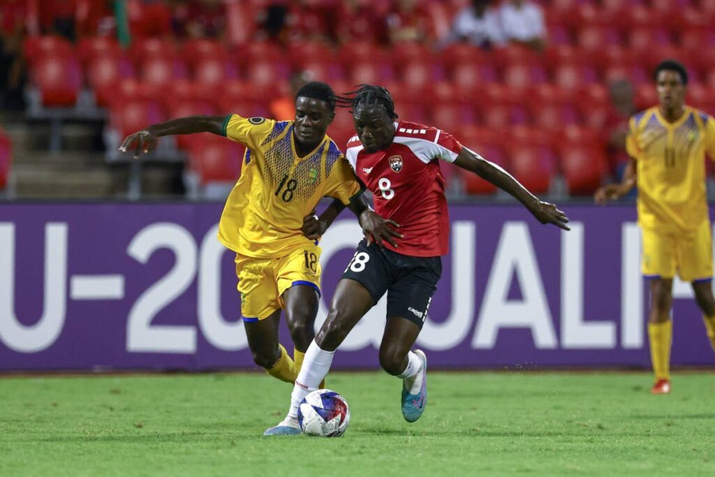 Trinidad and Tobago's Abayomi George (R) and St Vincent and the Grenandines' Mackellie Ferdinand battle for the ball during the Concacaf Under-20s Championship Group D qualifier match, on Friday, February 23rd at the Hasely Crawford Stadium, Port of Spain. PHOTO BY: Daniel Prentice