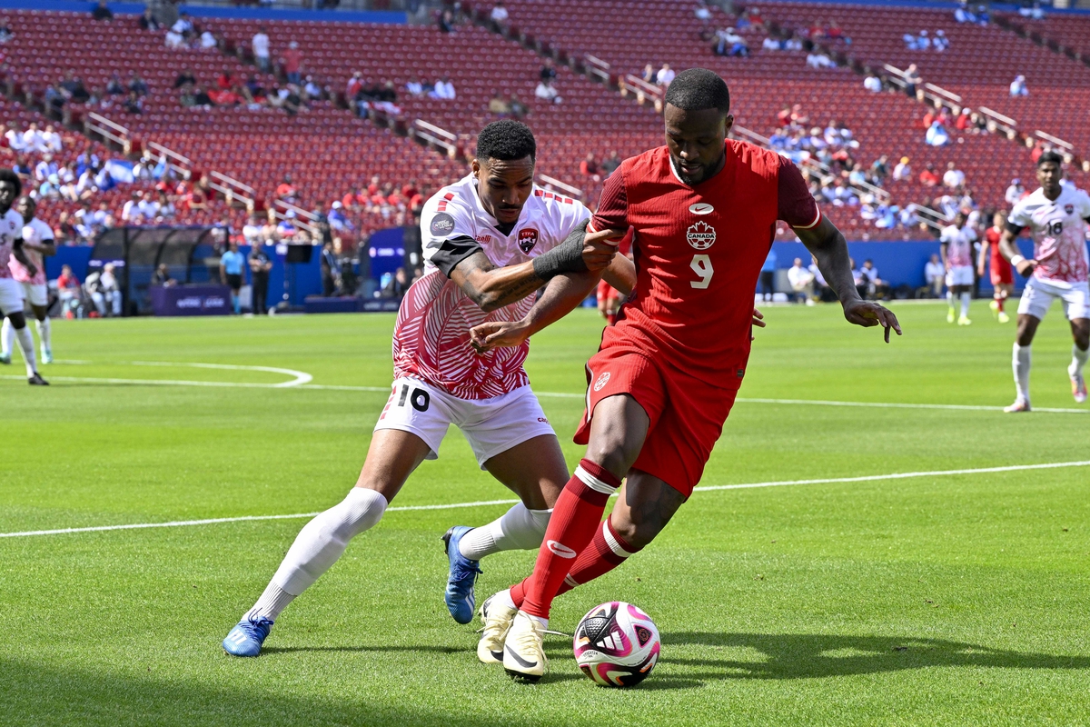 Mar 23, 2024; Frisco, Texas, USA; Canada forward Cyle Larin (9) keeps the ball away from Trinidad and Tobago defender Alvin Jones (16) during the first half at Toyota Stadium. Mandatory Credit: Jerome Miron-USA TODAY Sports
