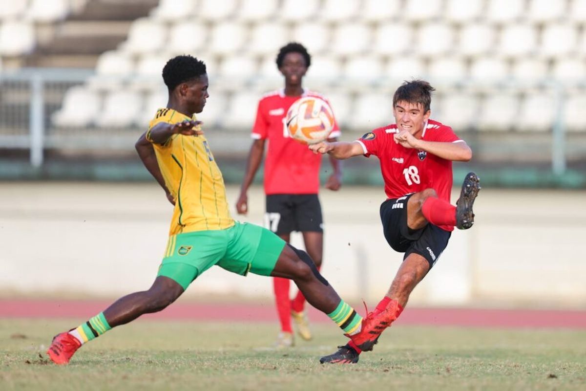 Trinidad and Tobago’s Michael Chaves (R) shoots wide while under pressure from Jamaica’s Rolando Barrett during an international U-20 practice match at the Larry Gomes Stadium on Thursday, February 1st 2024 in Malabar. PHOTO BY: Daniel Prentice