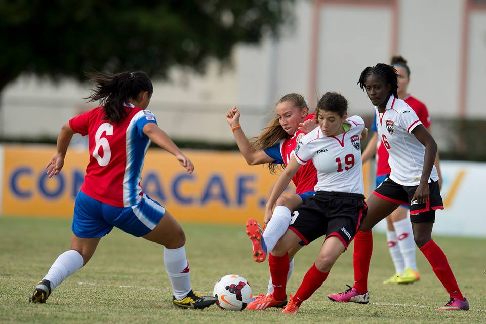 Trinidad & Tobago captain Anique Walker (#19) tries to hold off Costa Rica's Gloriana Villalobos in the third place match at the 2014 CONCACAF Women's Under-20 Championship.
