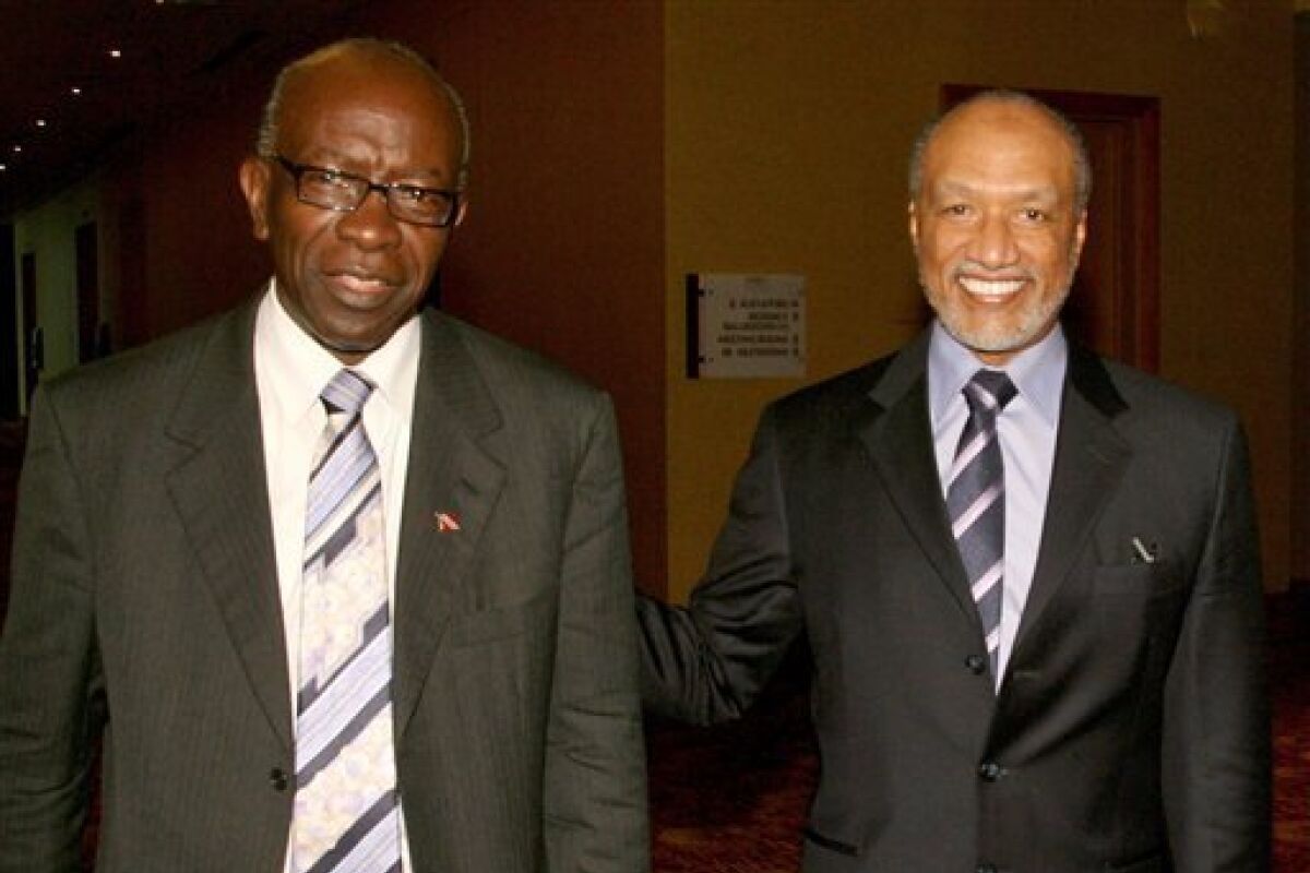 In this May 10, 2011 file picture Mohamed bin Hammam, right, of Qatar, chief of the Asian Football Confederation, is accompanied by FIFA Vice President Austin Jack Warner, of Trinidad & Tobago, during a meeting in Port of Spain, Trinidad & Tobago. (AP Photo/Shirley Bahadur)