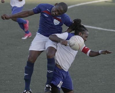 WASA’s captain, Marvin Faustin climbs over the shoulder of Real Maracas captain, Shane Glasgow, in an effort to win the ball in their Emerald Apartments & Plaza Eastern Football Association League Cup final, at Marvin Lee Stadium, Macoya, on Sunday. WASA won 1-0. Photo: Anthony Harris