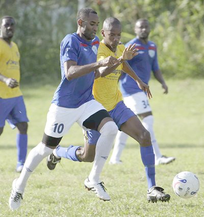 St Francois captain Marlon Bowen (right) gets past Immanuel Alexander of WASA during their bmobile National Super League encounter at the WASA ground St Joseph, yesterday. WASA won the match 1-0. Photo Anthony Harris.